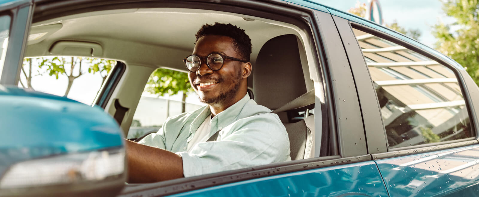 young man driving a car