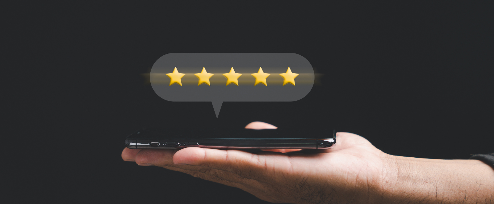 Person holding a phone with 5 stars above it