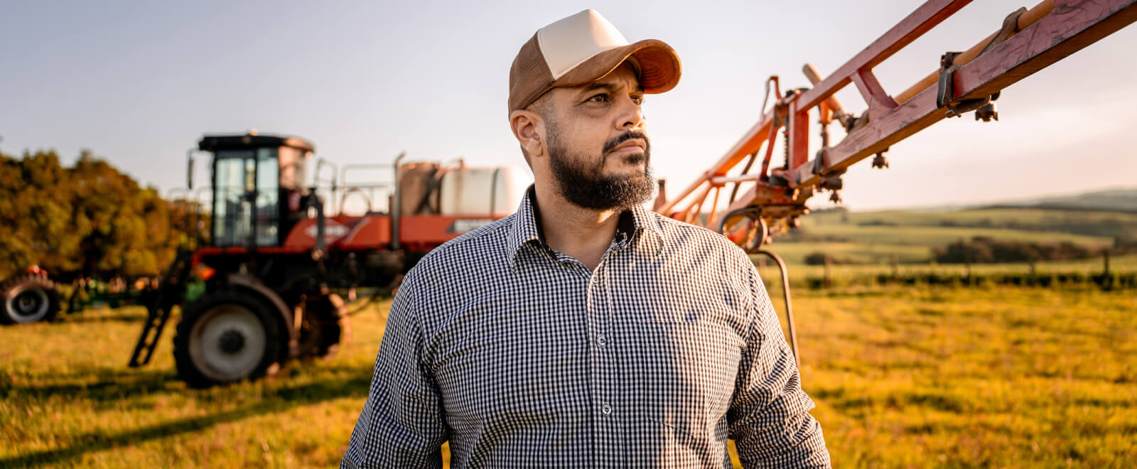 farmer inspecting farm equipment