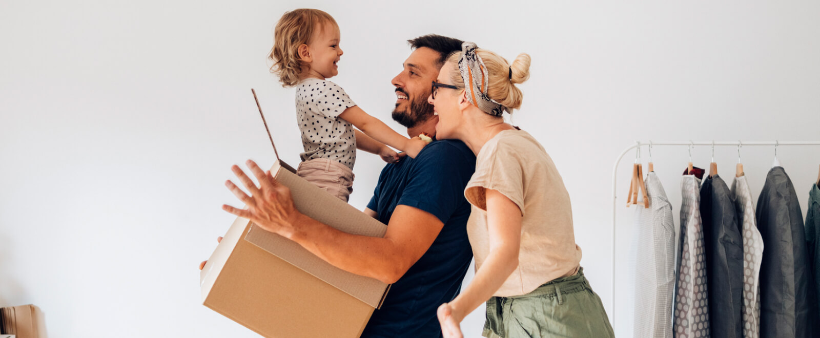 young family playing with a cardboard box