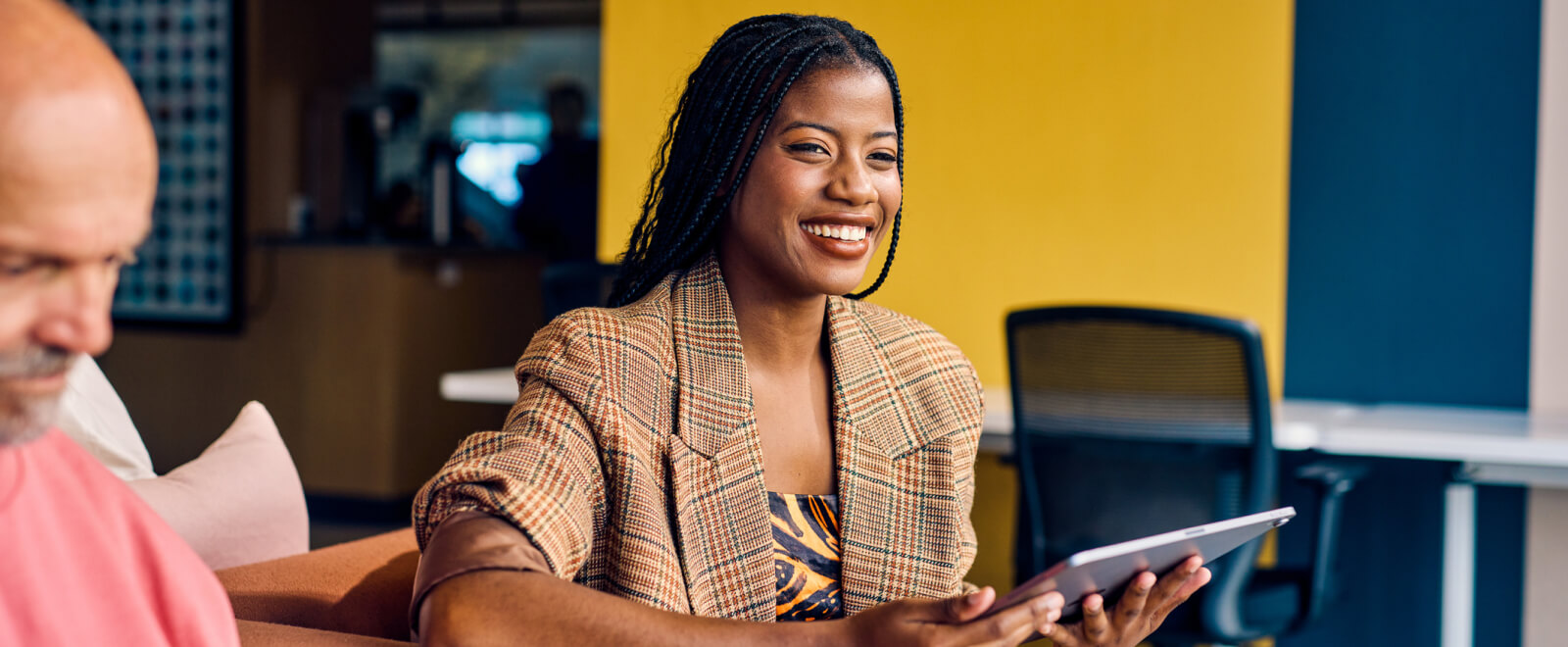 young business woman holding a tablet and smiling 