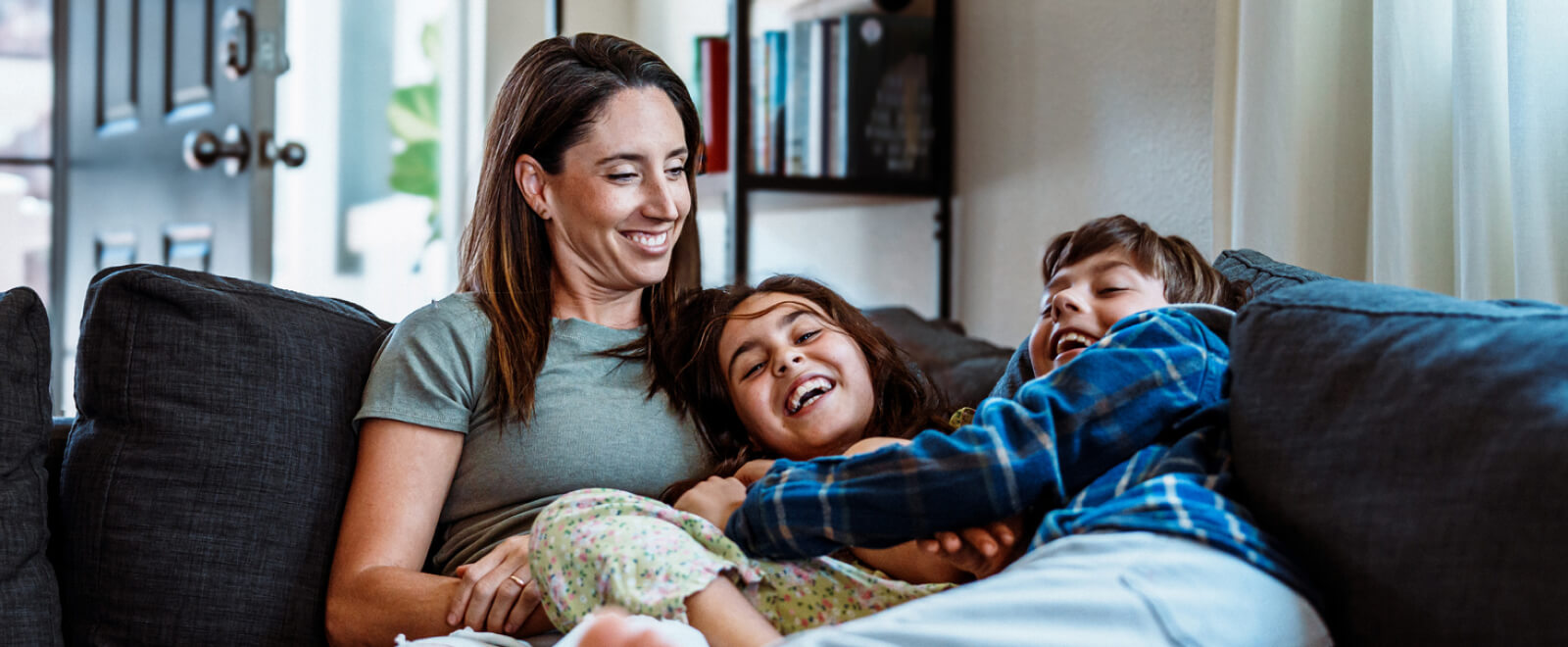Mom and kids playing on a couch