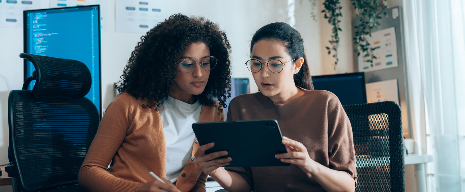 Two young business professionals looking at a tablet